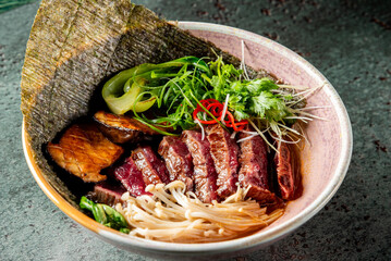 Poster - bowl of Asian noodles with vegetables, garnished with herbs. dish is presented in a rustic setting, emphasizing its fresh and appetizing appearance. Ideal for food-related content and culinary themes.