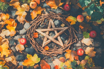 Pagan star shaped symbol made from branches in autumn forest or garden with red apples around. Mabon sabbat, Samhain. Autumn equinox holiday. Wiccan pagan religion. Magic or esoteric spiritual ritual