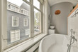 © ADDICTIVE STOCK - Cozy bathroom interior with view of urban surroundings