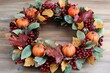 © Halina Berah - Handmade fall flower decoration workshop with rosehip berries, rowan, loose flowers, oak leaves, and dry flowers.