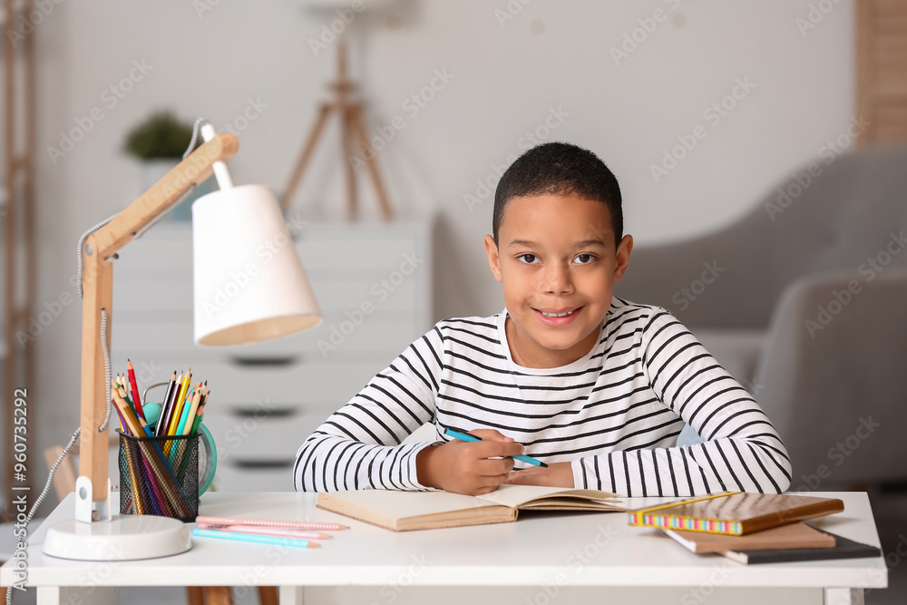 Little African-American boy doing lessons at home