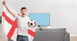 © Ljupco Smokovski - Excited young english football fan waving a flag in front of tv