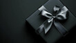 © Matthias - Matte black gift box with silver ribbon on elegant background