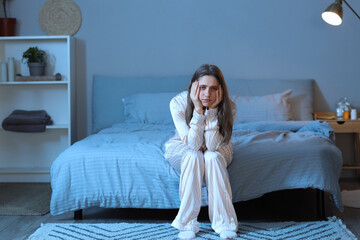 Wall Mural - Stressed young woman suffering from insomnia in bedroom at night