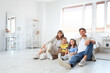 © Pixel-Shot - Happy parents with their little children sitting in bedroom