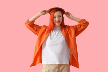 Poster - Beautiful young happy woman in beret on pink background