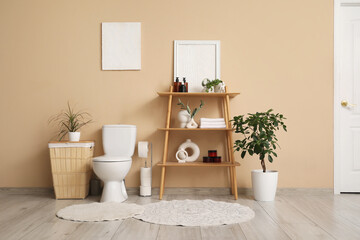 Canvas Print - Interior of restroom with toilet bowl, shelf unit and laundry basket