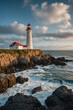 © eman - Vertical shot of a lighthouse standing tall on a rocky coast