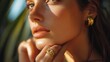© Nijat - A natural stone ring on the finger of a sophisticated woman. The female model wears a sophisticated gold ring on her finger. Pictures of jewelry for e-commerce, social media, and other platforms