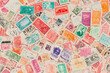 © Luluraschi - Seamless pattern of vintage postage stamps from around the world, slightly overlapping