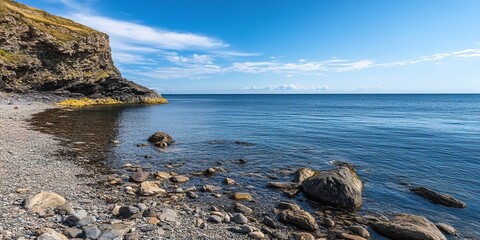 Wall Mural - a rocky beach with blue water and blue sky 