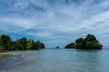 Clear Blue Water and Scenic Tropical Beach Surrounded by Palm Trees and Lush Nature - A Serene Island Paradise Offering Eco-Tourism and Adventure Travel in a Remote, Unspoiled Caribbean Destination