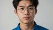 © Alteisen Riese - teen stunning brunette asian man with blue shirt model portrait standing straight on a plain white background for ad concept space for text