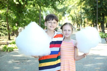 Sticker - Little girl and boy with sweet cotton candy in park