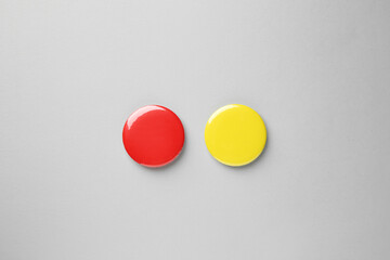 Sticker - Blank colorful button badges on grey background, top view. Mockup for design