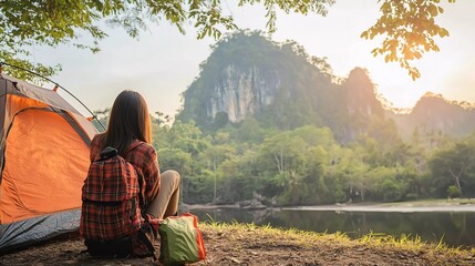 
Good morning. Asian woman traveling and camping alone at natural park in Thailand. Recreation and travel outdoor activity beautiful lifestyle