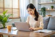 © Introvertia - Woman working on laptop in cozy home office setting