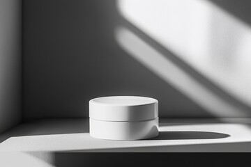 Wall Mural - A minimalist white container on a shelf, casting shadows in a softly lit environment.