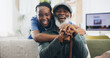 © peopleimages.com - Nurse, hug and old man with smile, home and happy for help, healthcare and friends with patient. Living room, embrace and wellness of senior person, walking stick and support of caregiver in house