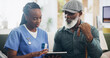© peopleimages.com - Nurse, senior man and tablet for telehealth, daily schedule and wellness in elderly care. Woman, person with a disability and tech for patient as medic for support, advice or checkup in nursing home