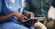 © peopleimages.com - Woman, nurse and hands with patient on tablet for telehealth, prescription or medical history at clinic. Closeup, healthcare employee or caregiver with man on technology for health tips or research