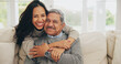 © Azee Jacobs/peopleimages.com - Hug, portrait and smile of old man with daughter on sofa in living room of home for bonding or visit. Face, family or love with happy woman and senior father embracing in apartment together