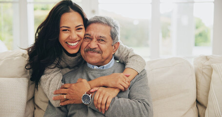 Poster - Hug, portrait and smile of old man with daughter on sofa in living room of home for bonding or visit. Face, family or love with happy woman and senior father embracing in apartment together