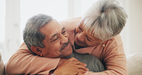 Canvas Print - Hug, relax and senior couple with love, happiness and care with retirement, comfort and bonding together. Apartment, embrace and mature woman with elderly man on sofa, house and support in lounge