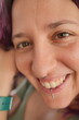 © AdriFerrer - A woman with a nose piercing is smiling and looking at the camera