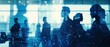 © Iona - Silhouettes of business people in a modern office, overlaid with abstract digital connections, conveying technology, networking, and collaboration themes