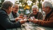 © Lumos Maxima - Happy joyful group of seniors playing cards