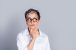 © deagreez - Portrait of elegant aged lady office worker look empty space ponder wear shirt isolated on grey color background