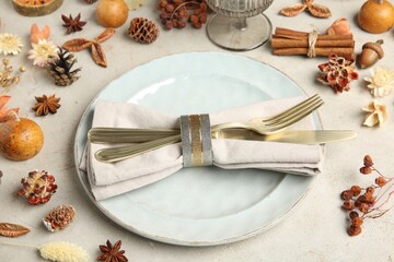 Poster - Stylish place setting, cinnamon and dry flowers on grey textured table