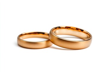 Two gold wedding rings on a white background, symbolizing love and commitment.