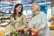 © Dragana Gordic - Happy Women Shopping Together in a Grocery Store
