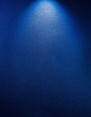 Wall Mural - Dark blue wall gradient. HD quality. Gentle illumination falls from above, highlighting subtle texture variations, deepening shadows, creating a captivating visual contrast, and enhancing the rich, in