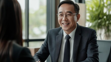 Businessman Smiling During a Professional Meeting in a Modern Office Setting with Natural Light