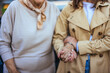 © Dragana Gordic - Elderly Woman and Younger Companion Holding Hands in Comfort