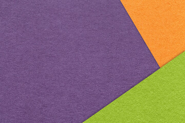 Texture craft violet paper background with orange and green border. Vintage abstract purple cardboard.