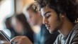 © BerkahStock - A young man focused on a tablet, surrounded by others engaged in similar activities.