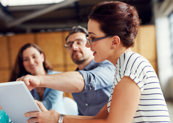 Wall Mural - Employees, teamwork and smile on tablet at office in meeting for business collaboration and ideas web designer. People, coworking and happy in boardroom on website for review on creative project