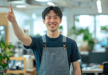 Poster - A Japanese man in his thirties, wearing work , smiles and points to the upper left with one hand, set against an office background.