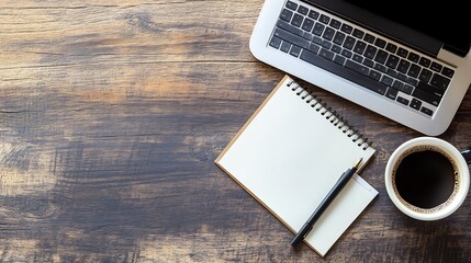 Top View of a Workspace with Laptop, Notebook, and Coffee