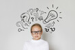 © millaf - Young child girl in guggles with light bulb and question marks looking at camera on white background. Education and idea concept
