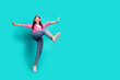 © deagreez - Full body photo of lovely teen lady headphones dance step dressed stylish pink garment isolated on cyan color background