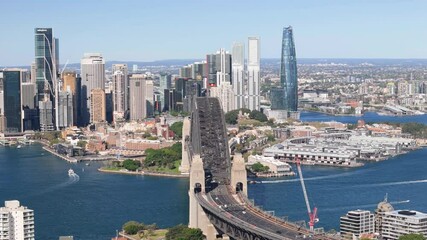 Wall Mural - Aerial drone pullback reverse view of Sydney City, the Sydney Harbour above the Harbour Bridge on a sunny day in August 2024 