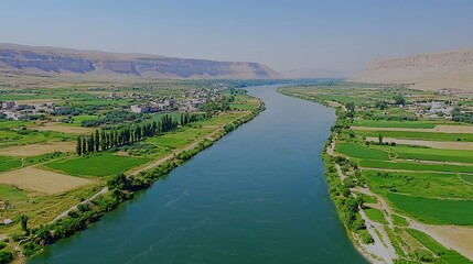 Serene landscape of a river winding through lush green fields and hills.