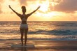 © fabioderby - Young lady finds serenity while doing yoga on the beach at sunrise