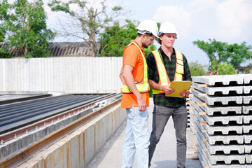 Engineer and Employee Working at Construction Site.