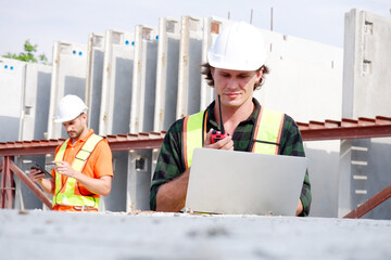 Engineer working at construction site Engineer inspecting precast concrete wall.